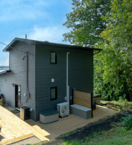 Inspecting an outdoor air conditioning unit during summer home maintenance